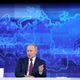 Russian president Vladimir Putin sitting in front of a large blue map of the Europe and Asia. Hackers working on behalf of Putin are escalating their attacks on Ukraine, according to new research presented at the Black Hat conference.